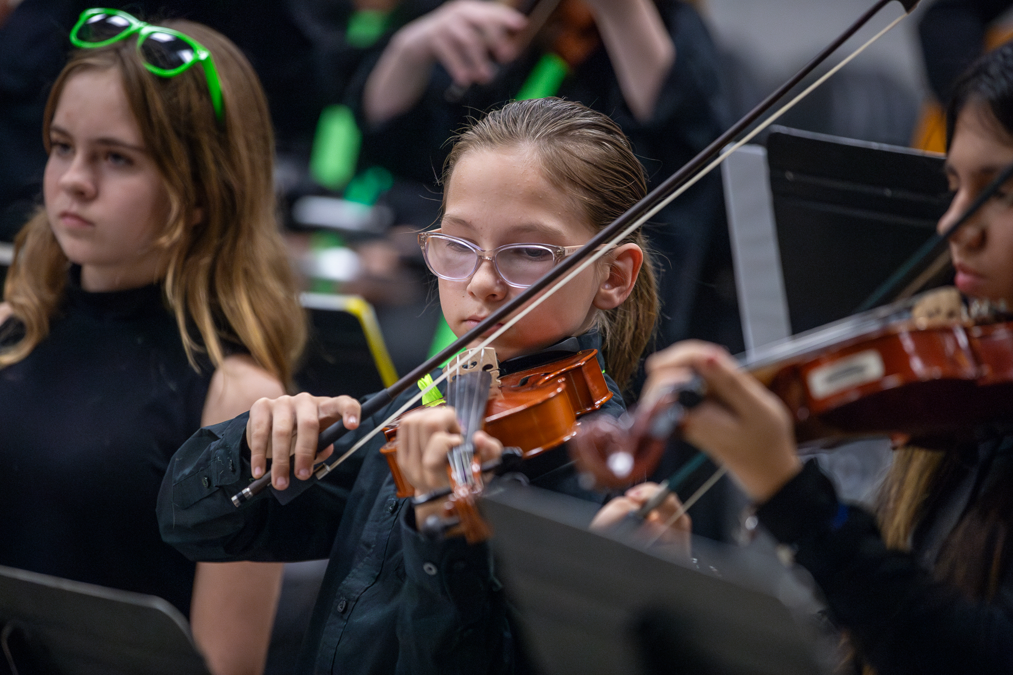 Three girls play their violins