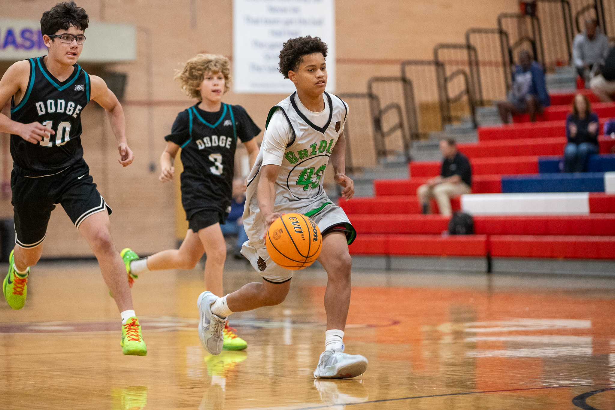 A Gridley player dribbles the ball away from his opponents on the Dodge team