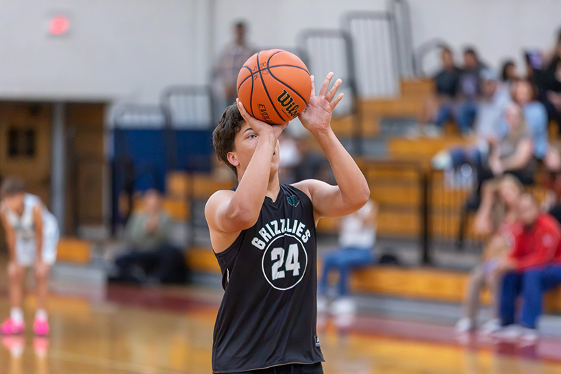A boy gets ready to shoot the basketball
