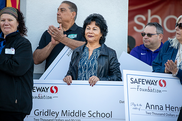 Gridley's principal holds the check from the Safeway Foundation